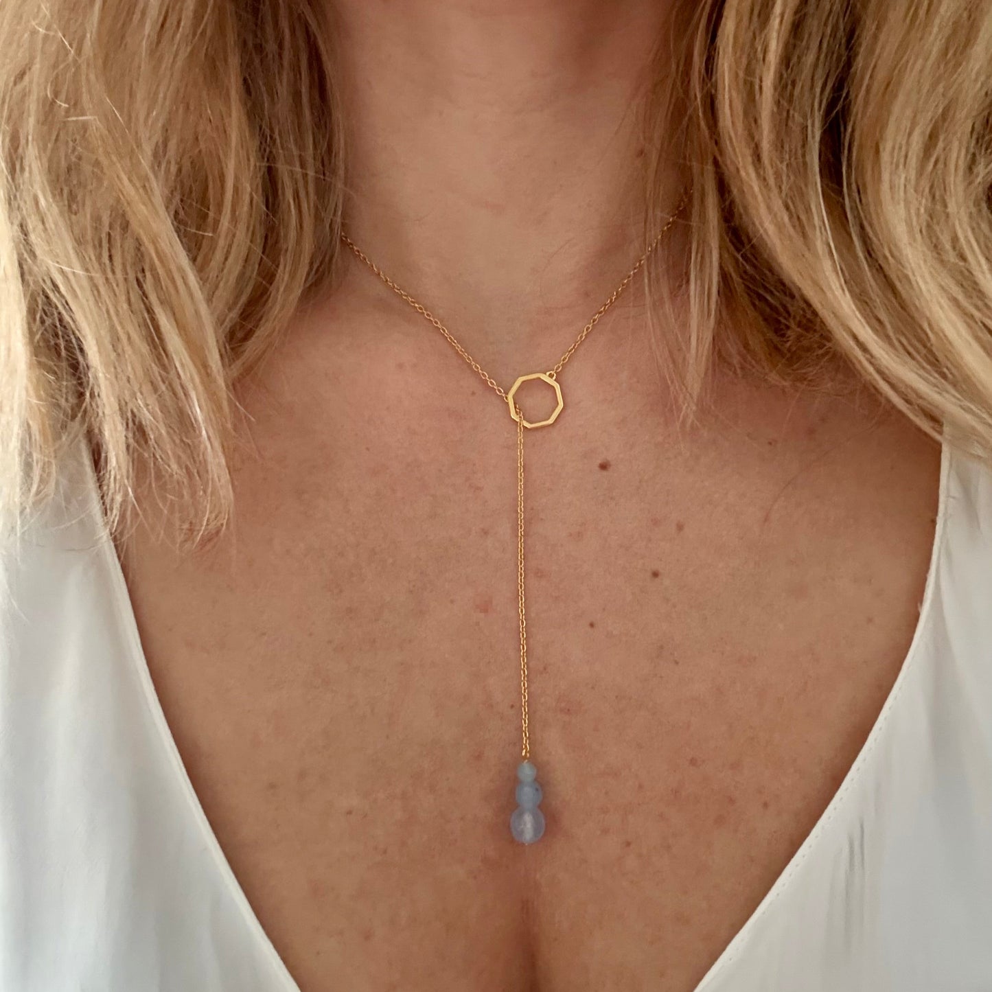Wearing drop gold necklace aquamarine