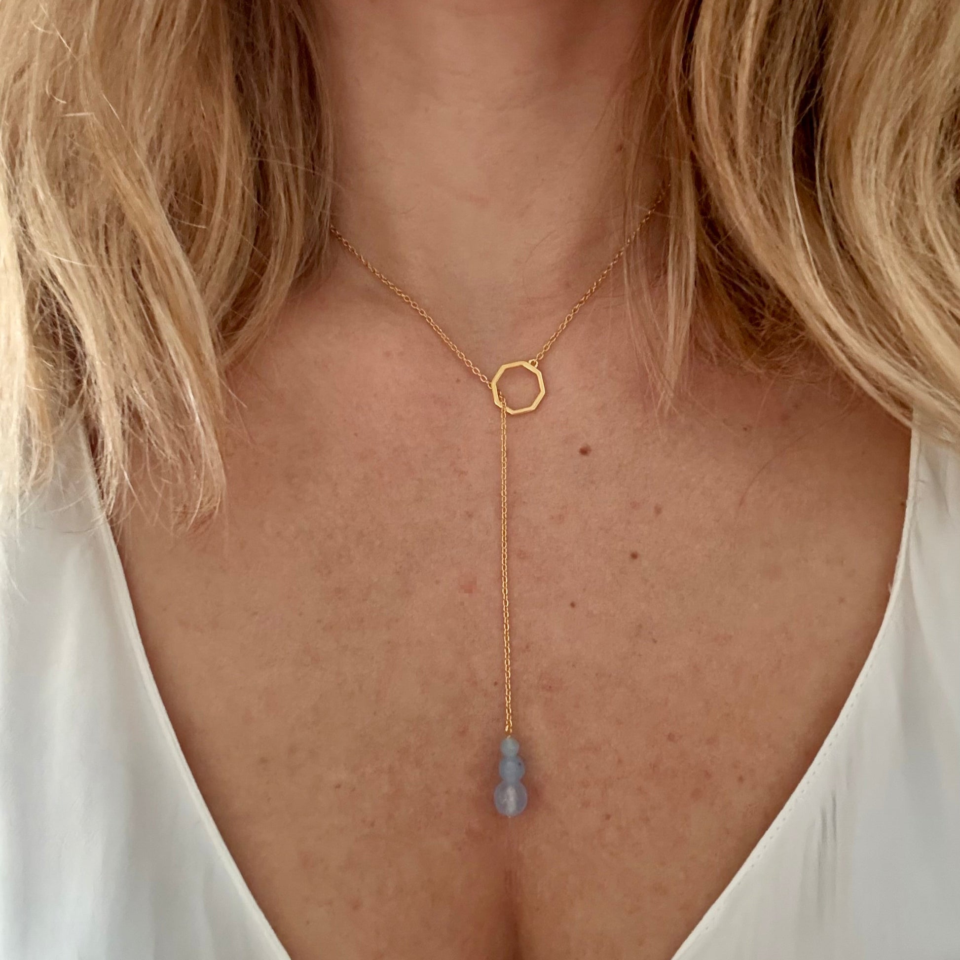Wearing drop gold necklace aquamarine