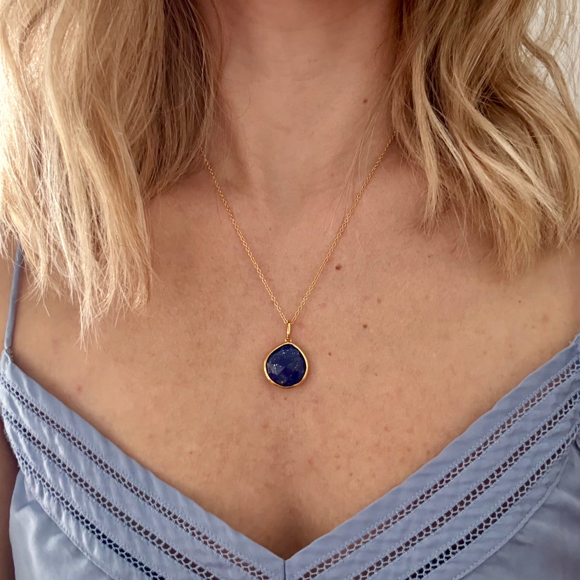 Wearing gold lapis lazuli pear pendant necklace