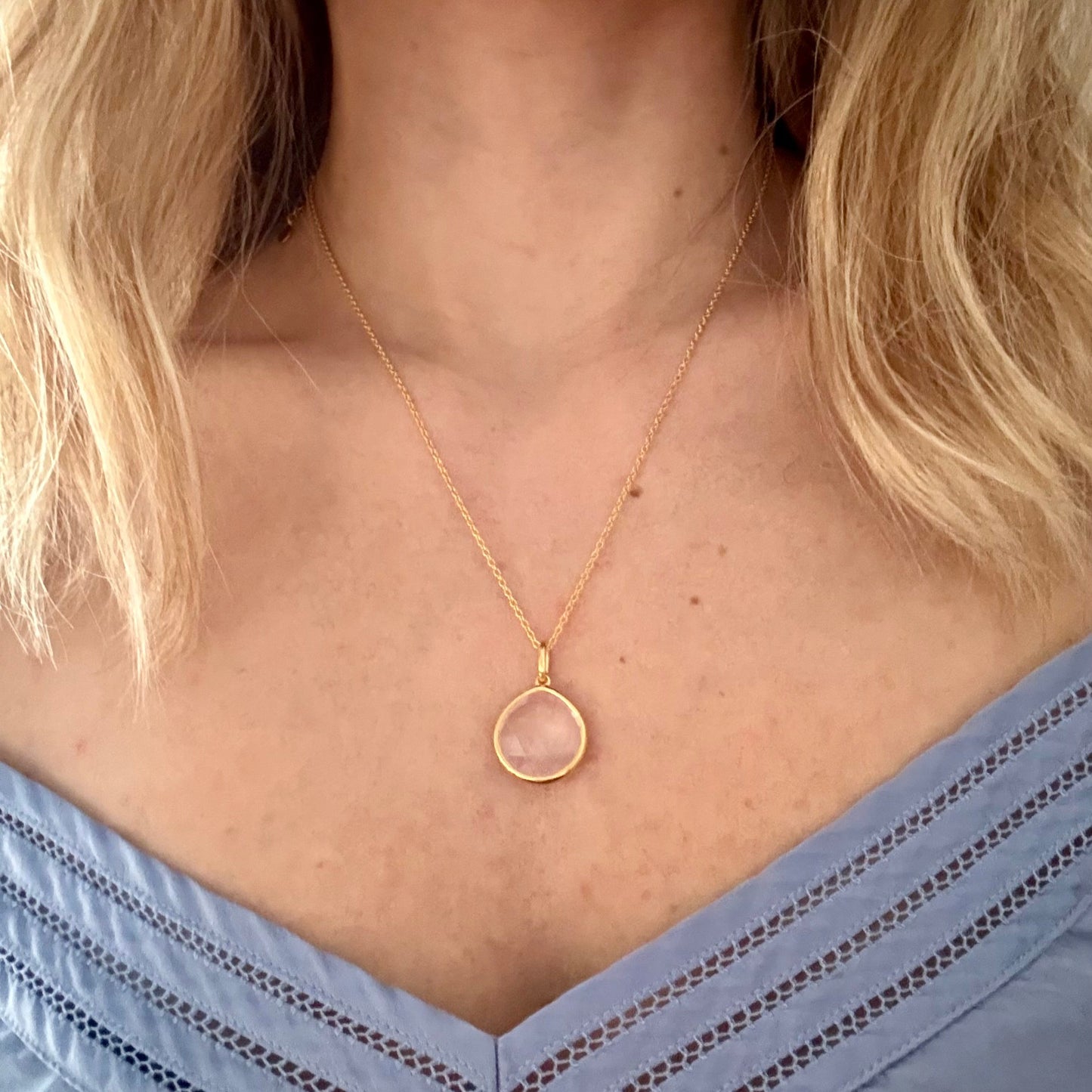 Wearing gold rose quartz pear pendant