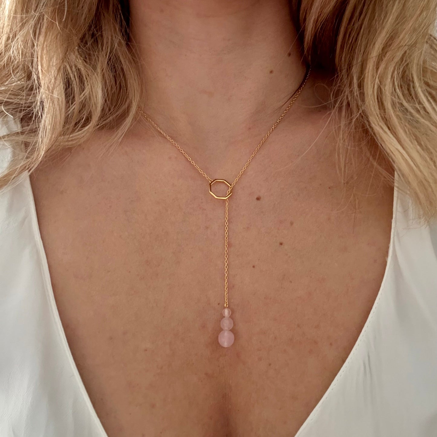 Wearing drop necklace gold rose quartz