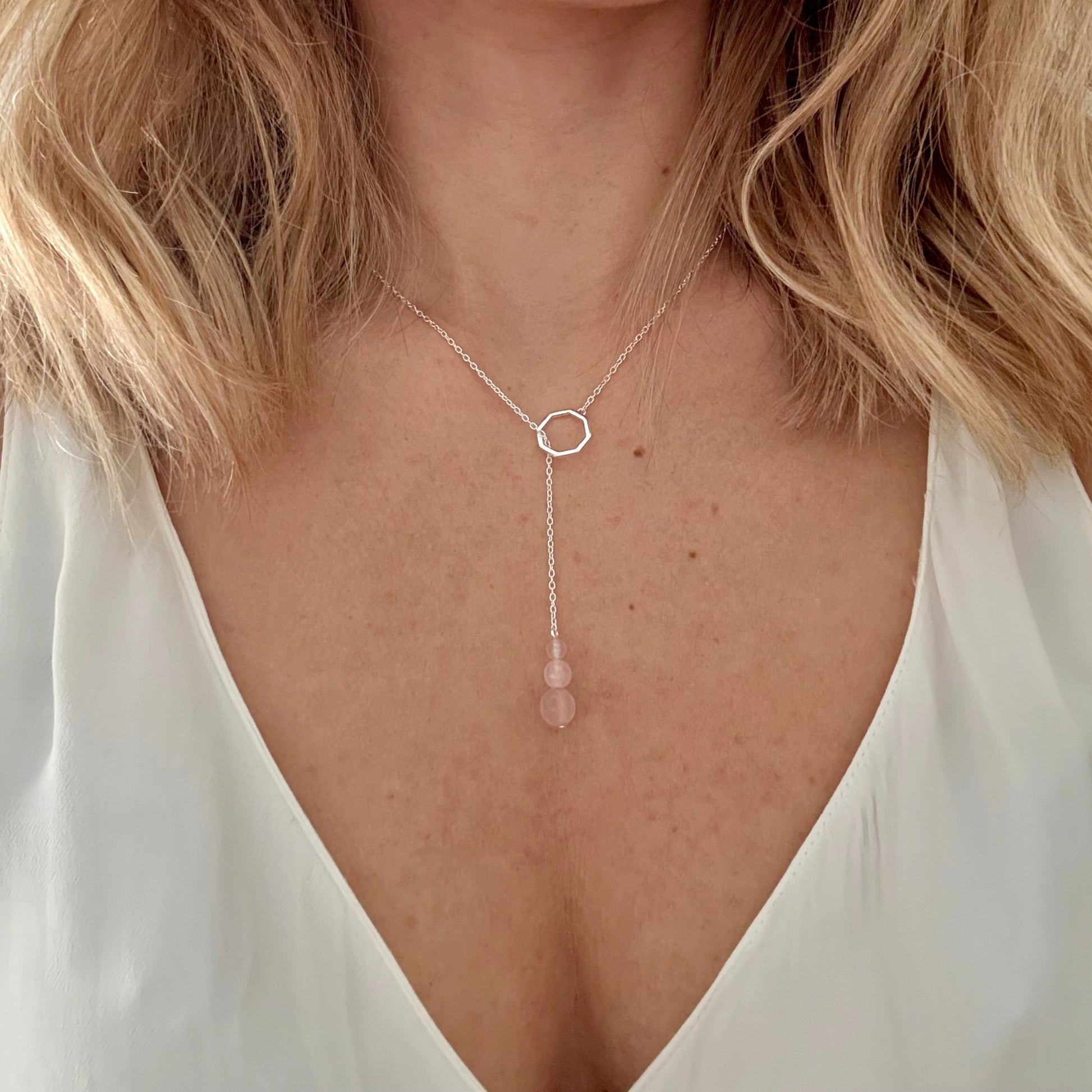 Wearing drop silver necklace rose quartz